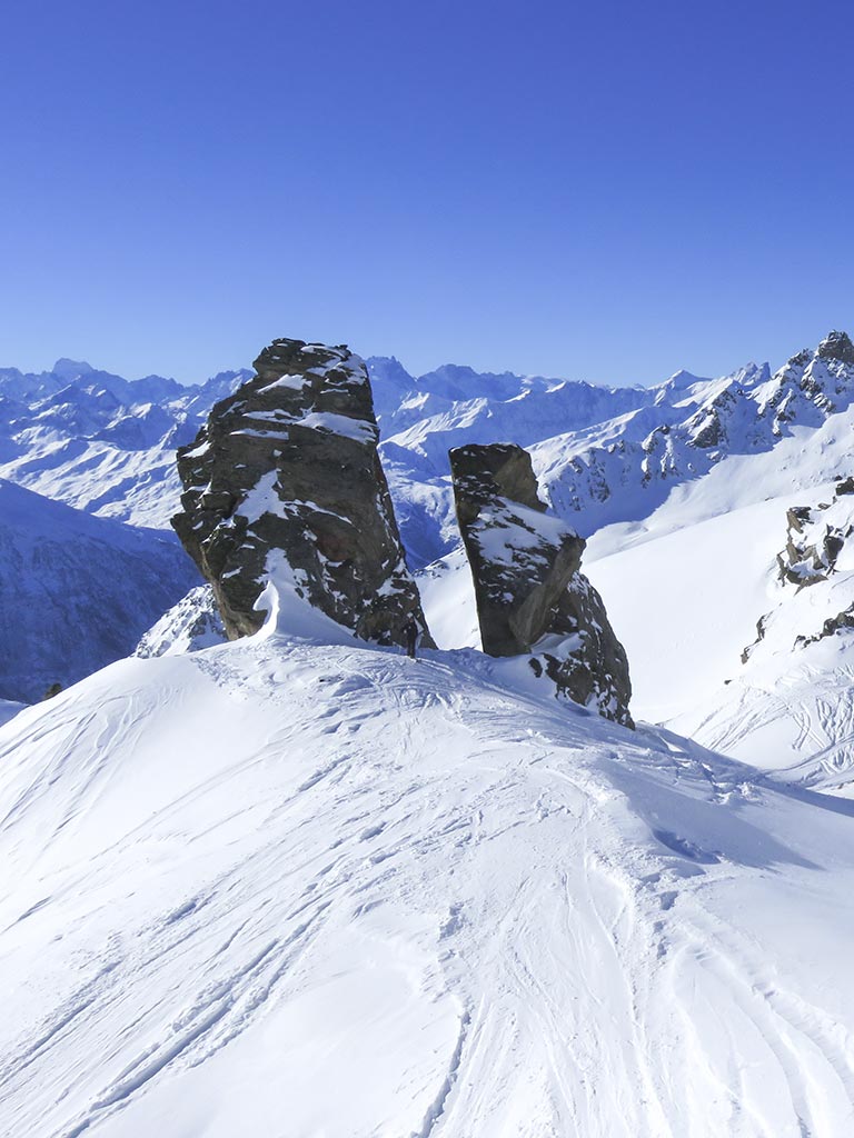 A huge rock split as if it had been sawn on a snowy ridge.